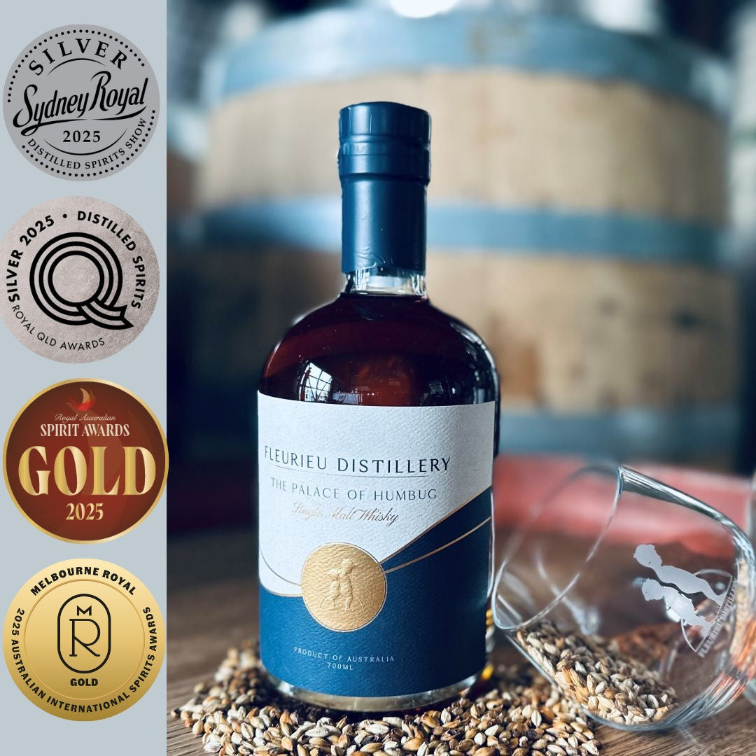Bottle of Fleurieu Distillery whisky with awards on the left and a glass on the right.